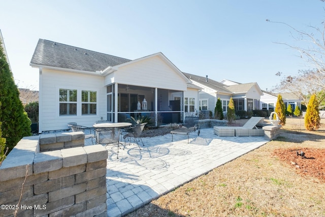 rear view of property with a sunroom and a patio