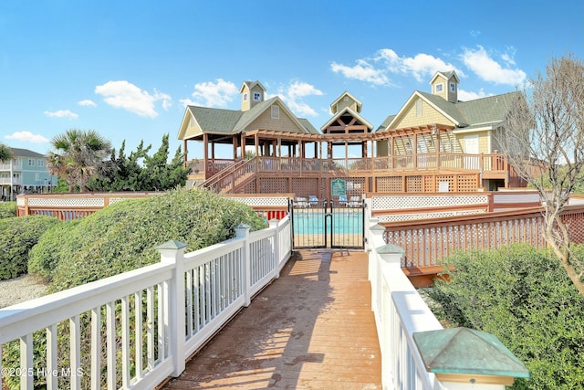 back of house featuring a community pool