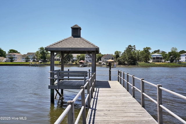 dock area featuring a gazebo and a water view