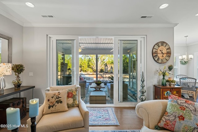 entryway featuring ornamental molding, a chandelier, and wood-type flooring