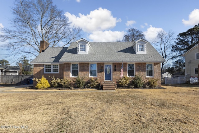 cape cod-style house with a front lawn