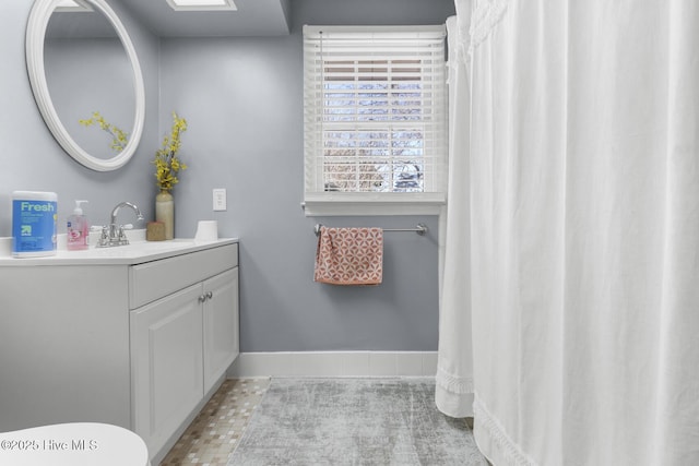 bathroom featuring tile patterned flooring and vanity