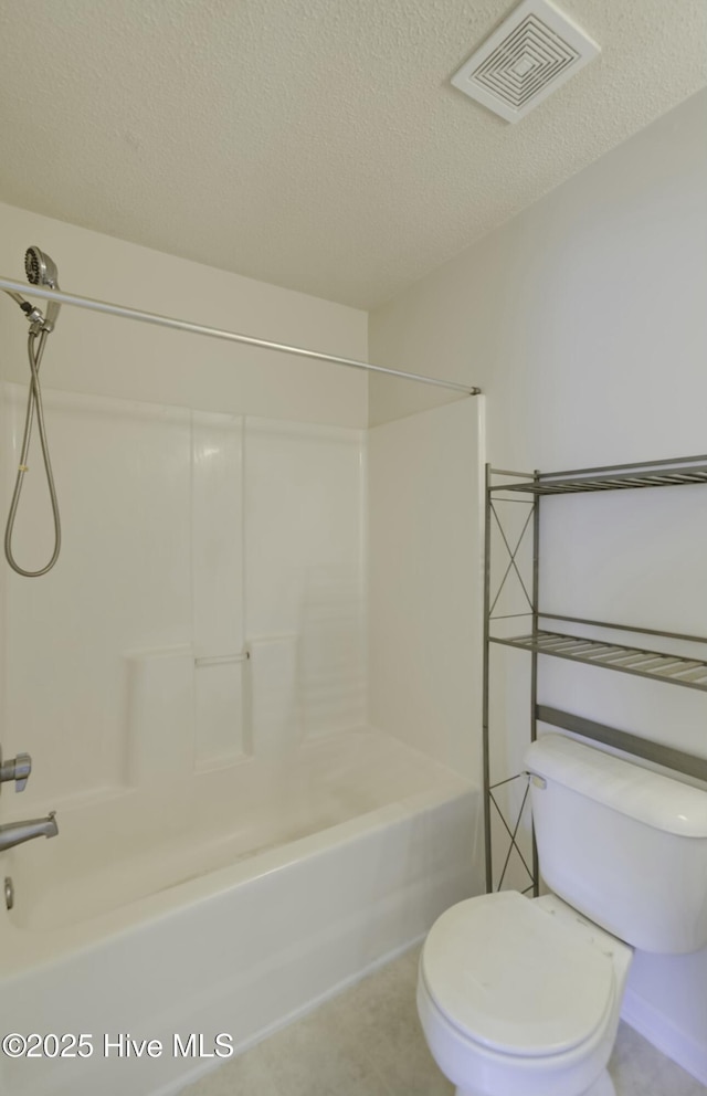 bathroom with toilet, a textured ceiling, and bathtub / shower combination