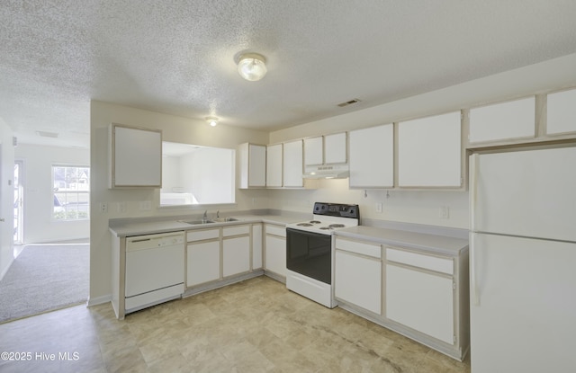 kitchen featuring white appliances, white cabinets, and sink