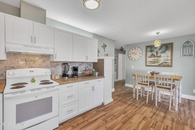 1126 Ccc Rd, Sneads Ferry, NC 28460 - kitchen with decorative light fixtures, backsplash, white electric range, white cabinetry, and a textured ceiling