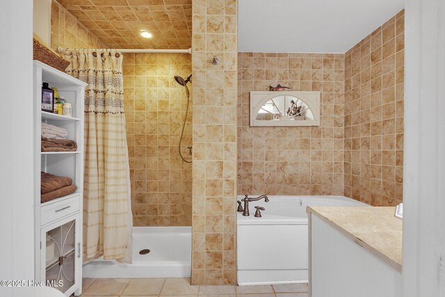 1126 Ccc Rd, Sneads Ferry, NC 28460 - bathroom featuring vanity, independent shower and bath, tile walls, and tile patterned floors