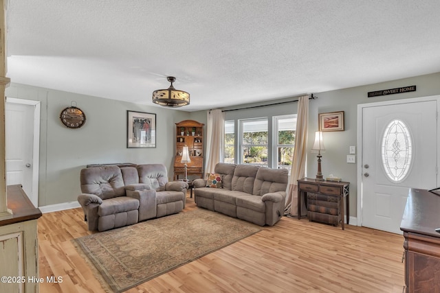1126 Ccc Rd, Sneads Ferry, NC 28460 - living room with a textured ceiling and light hardwood / wood-style floors