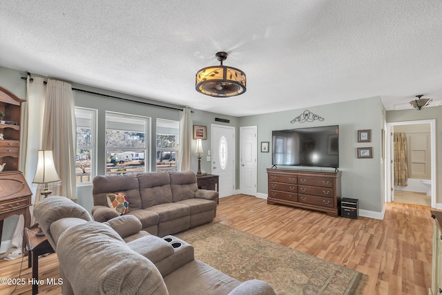 1126 Ccc Rd, Sneads Ferry, NC 28460 - living room featuring a textured ceiling and light wood-type flooring