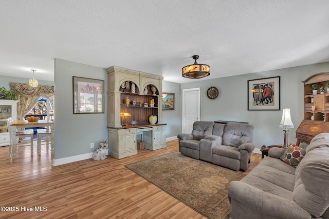 1126 Ccc Rd, Sneads Ferry, NC 28460 - living room with a textured ceiling and light wood-type flooring