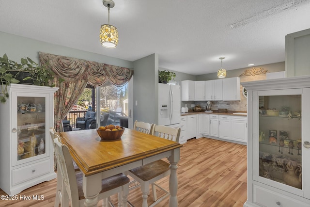 1126 Ccc Rd, Sneads Ferry, NC 28460 - dining space featuring light wood-type flooring and a textured ceiling