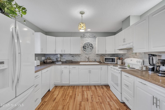 1126 Ccc Rd, Sneads Ferry, NC 28460 - kitchen featuring sink, white appliances, white cabinets, and hanging light fixtures