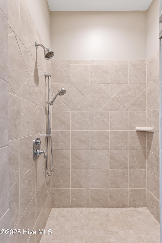 bathroom with tiled shower