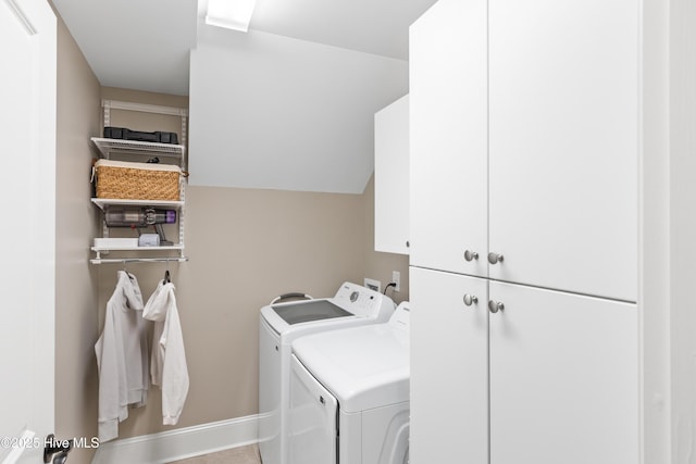 laundry room with washer and clothes dryer and cabinets