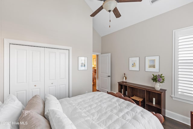 bedroom featuring ceiling fan, a closet, multiple windows, and dark hardwood / wood-style floors