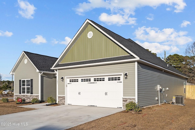 craftsman-style house with a garage and central AC