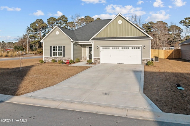 view of front of home featuring a garage and cooling unit