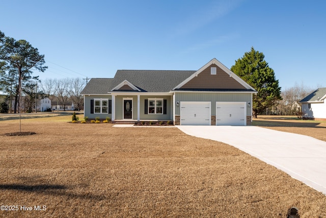 craftsman house featuring a garage and a front lawn