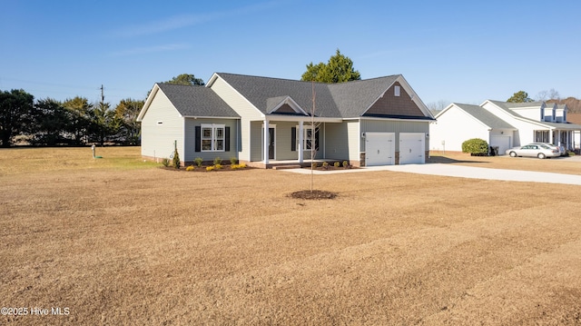 view of front facade with a garage, a porch, and a front yard