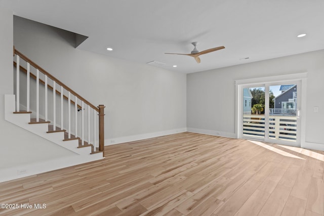 unfurnished living room with light wood-type flooring and ceiling fan