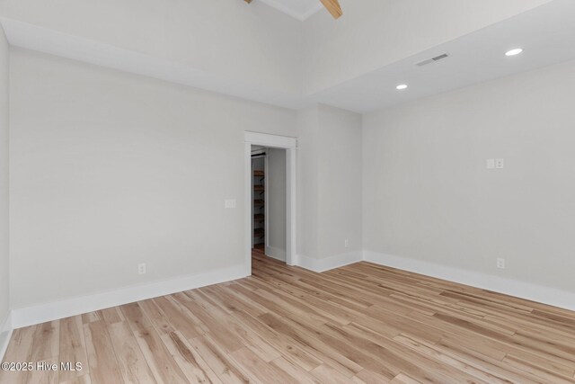 interior space featuring beam ceiling, ceiling fan, and light hardwood / wood-style flooring