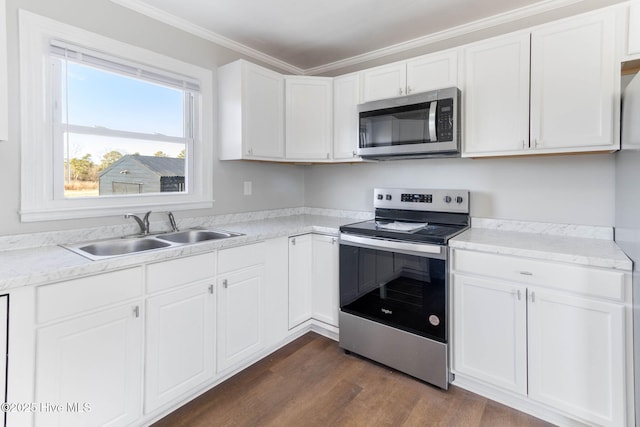 kitchen with sink, white cabinetry, appliances with stainless steel finishes, ornamental molding, and dark hardwood / wood-style flooring