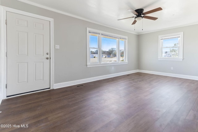 interior space with ceiling fan, a wealth of natural light, crown molding, and dark hardwood / wood-style floors