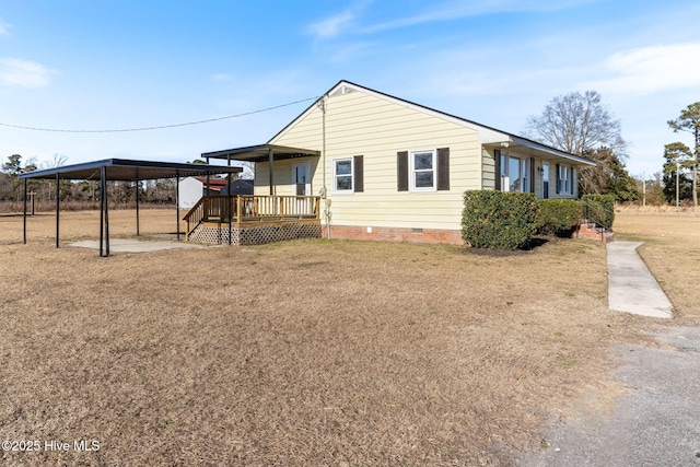 exterior space featuring a front lawn and a deck