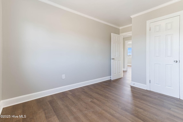 unfurnished bedroom featuring dark wood-type flooring, a closet, and crown molding