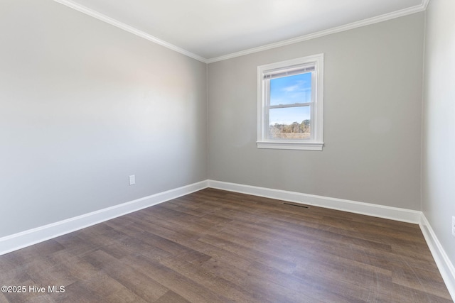 spare room featuring dark hardwood / wood-style flooring and ornamental molding