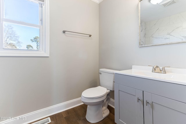 bathroom featuring toilet, hardwood / wood-style floors, and vanity