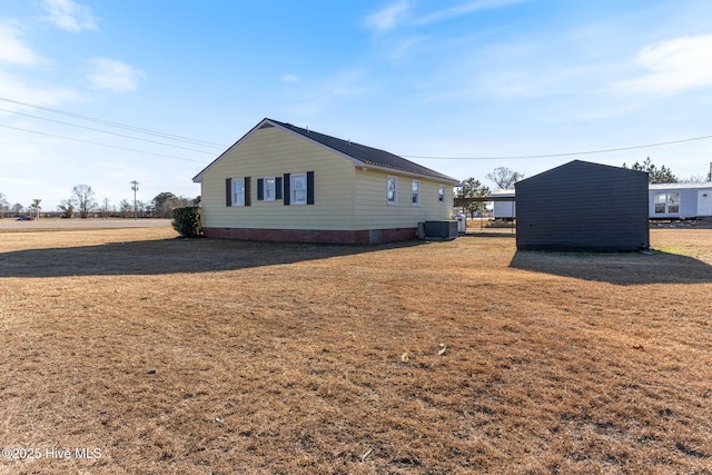 view of property exterior featuring a yard and central air condition unit