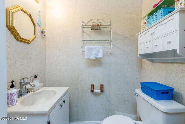 bathroom with toilet and vanity