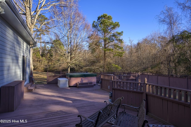 wooden terrace with a hot tub