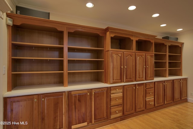 mudroom with crown molding and light wood-type flooring