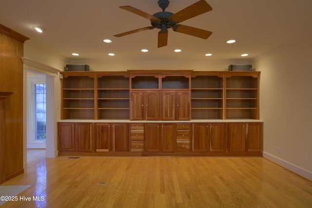 unfurnished living room with baseboards, recessed lighting, crown molding, a ceiling fan, and light wood-style floors