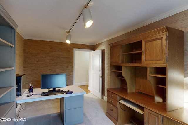 office area featuring track lighting, crown molding, light colored carpet, and built in study area