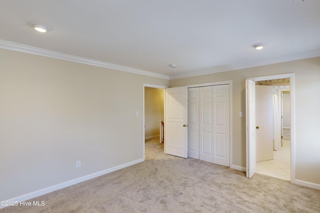 unfurnished bedroom with light colored carpet, a closet, and crown molding