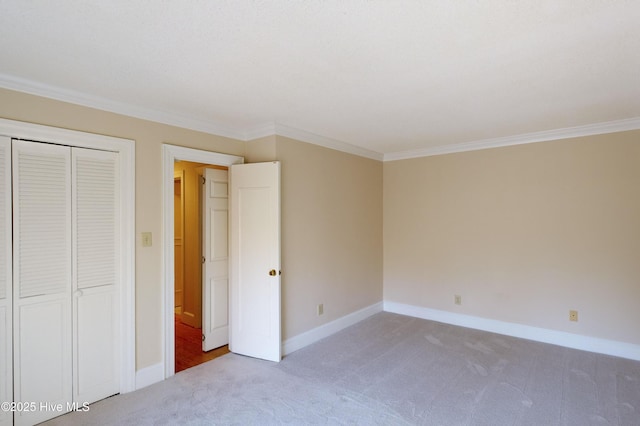 unfurnished bedroom with light carpet, a closet, and ornamental molding