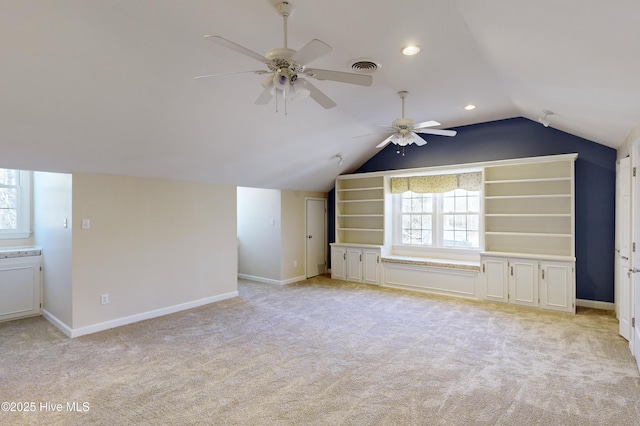 bonus room with visible vents, baseboards, ceiling fan, vaulted ceiling, and light colored carpet