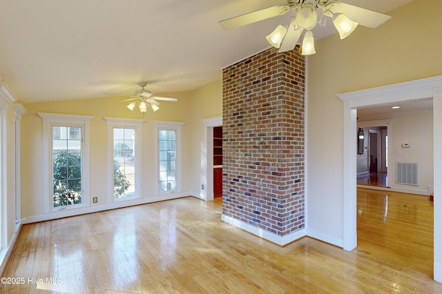 unfurnished living room with baseboards, vaulted ceiling, light wood-style flooring, a ceiling fan, and visible vents