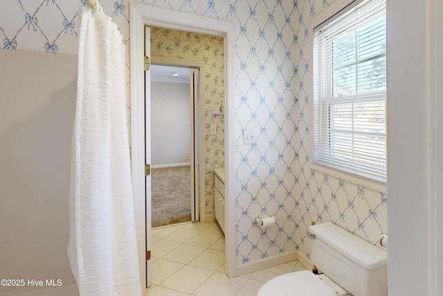 bathroom with toilet and tile patterned floors