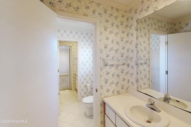 bathroom featuring tile patterned flooring, vanity, wallpapered walls, and toilet
