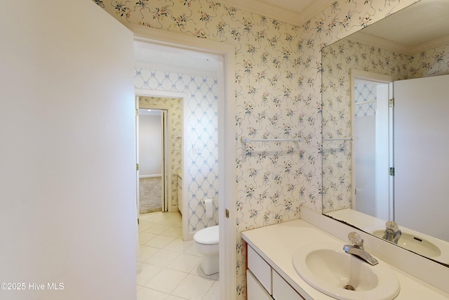 bathroom featuring toilet, tile patterned flooring, crown molding, and vanity