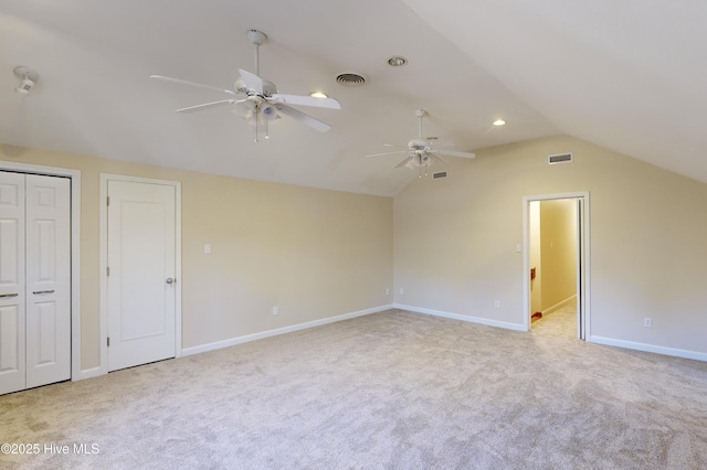 interior space featuring visible vents, ceiling fan, carpet, and lofted ceiling