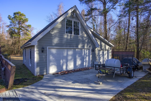 view of home's exterior with a garage and an outbuilding