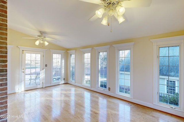 unfurnished room with wood finished floors, ceiling fan, baseboards, and a healthy amount of sunlight