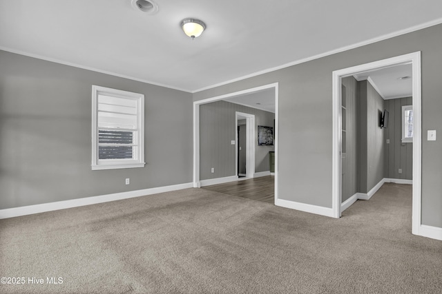 carpeted spare room with crown molding