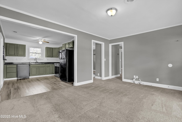 unfurnished living room with light carpet, ceiling fan, crown molding, and sink