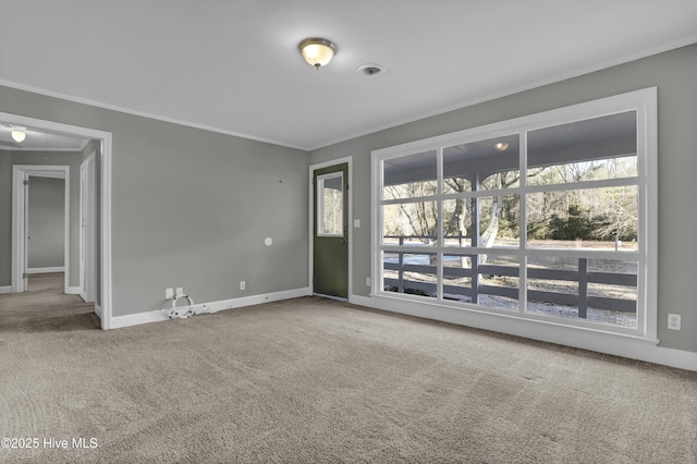 carpeted empty room featuring crown molding