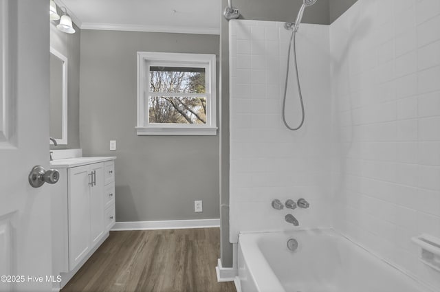 bathroom featuring vanity, tiled shower / bath combo, crown molding, and hardwood / wood-style flooring